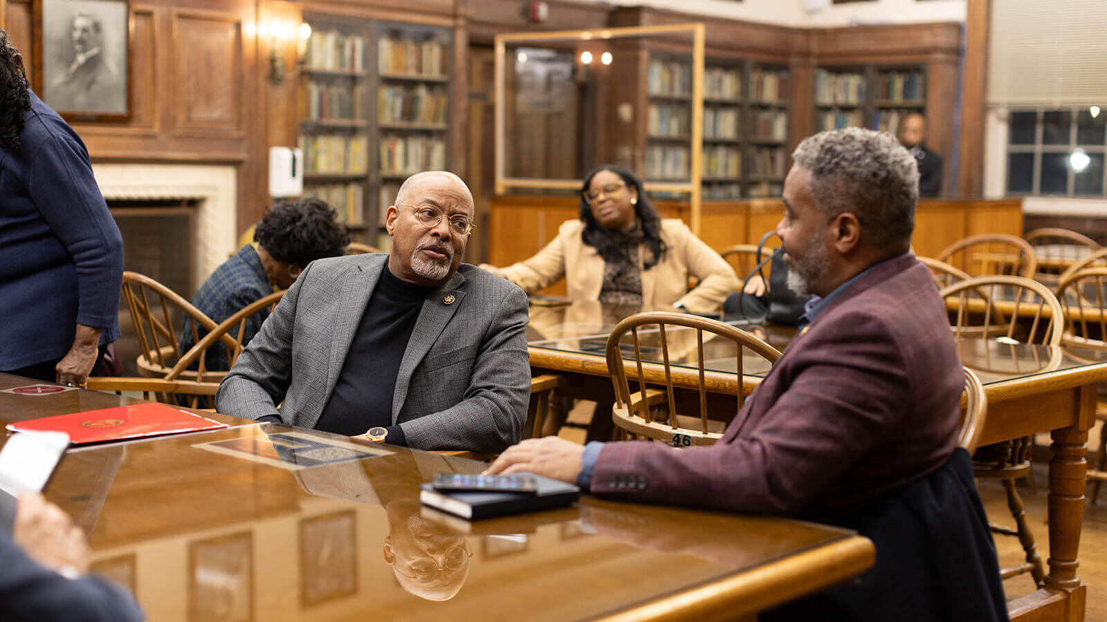 Two men talking in a Howard University library