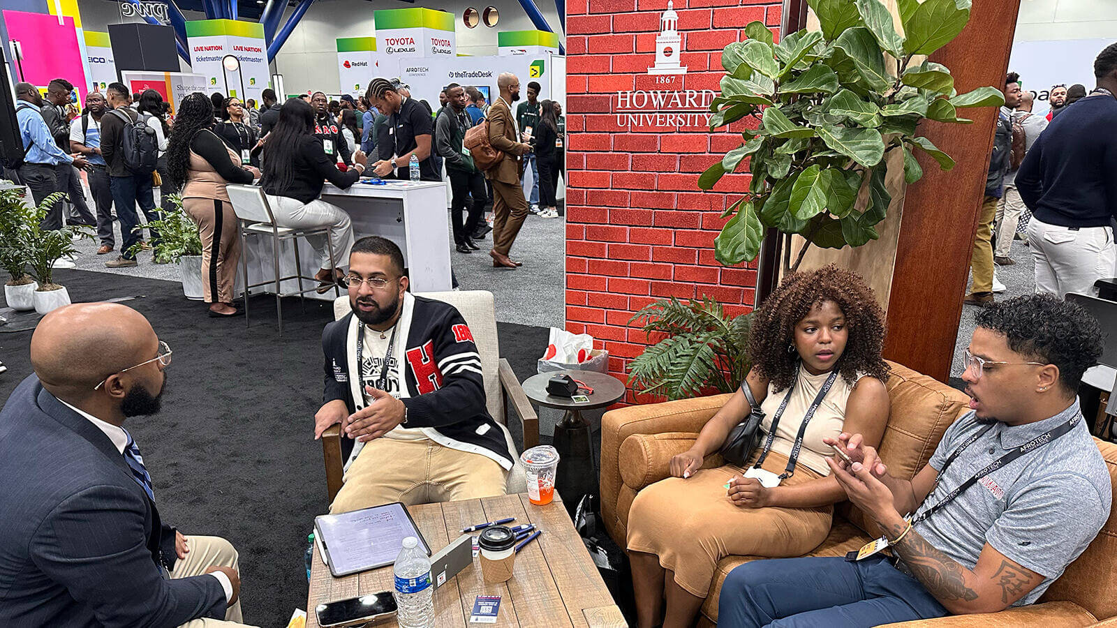 Afro Tech team taking a moment to chat and connect in a lively conference hall