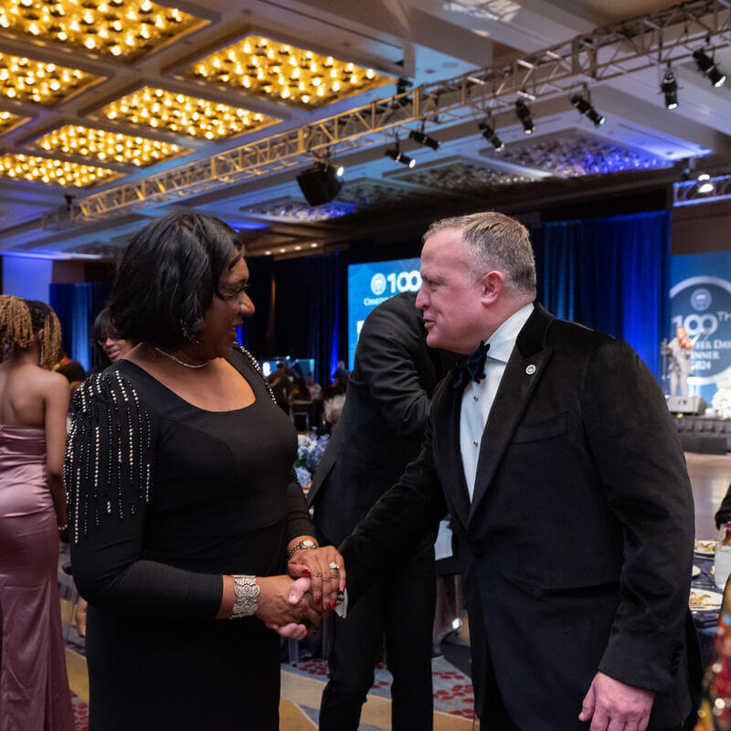 Vice President of DAR David Bennett shaking an attendee’s hand