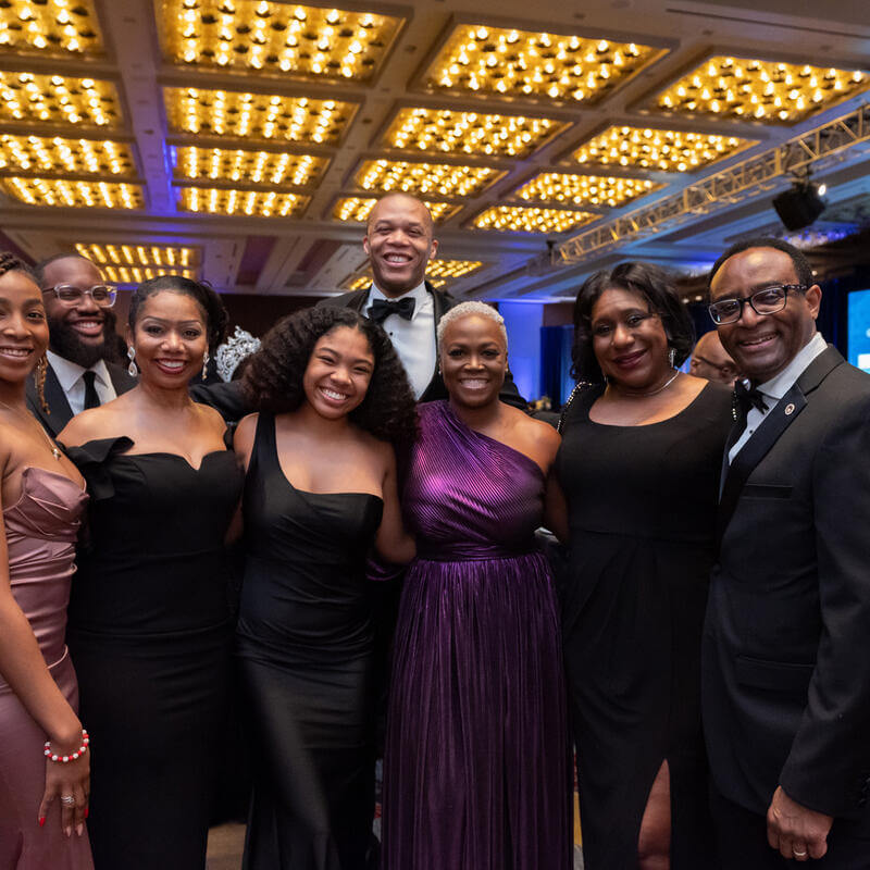 7 attendees posing with President Vinson