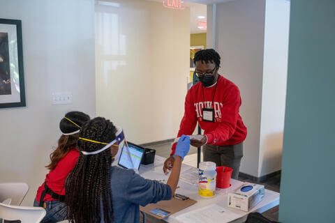 Students wearing PPE in a residential setting.