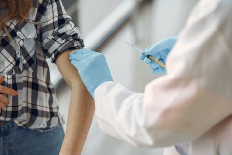 A doctor vaccinating a patient.