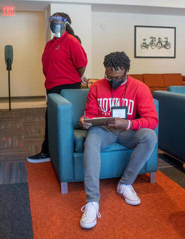 Howard students in a dorm wearing PPE.