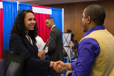 Man and woman shaking hands at an employment event