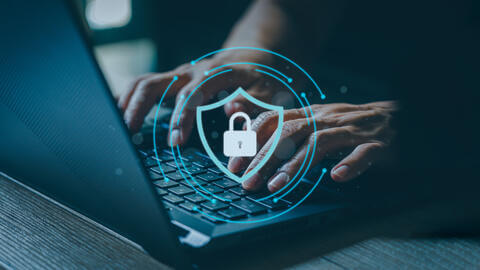 Hands typing on a keyboard with a lock in the center